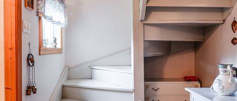 A staircase leading to a loft bedroom with a view of the outdoors.