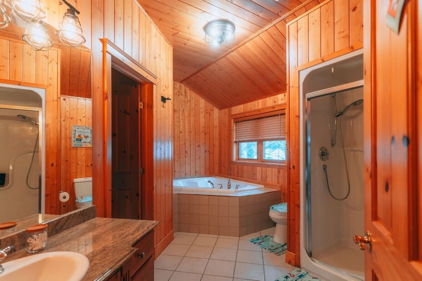 A wooden cabin bathroom with a bathtub, shower, and a sink.