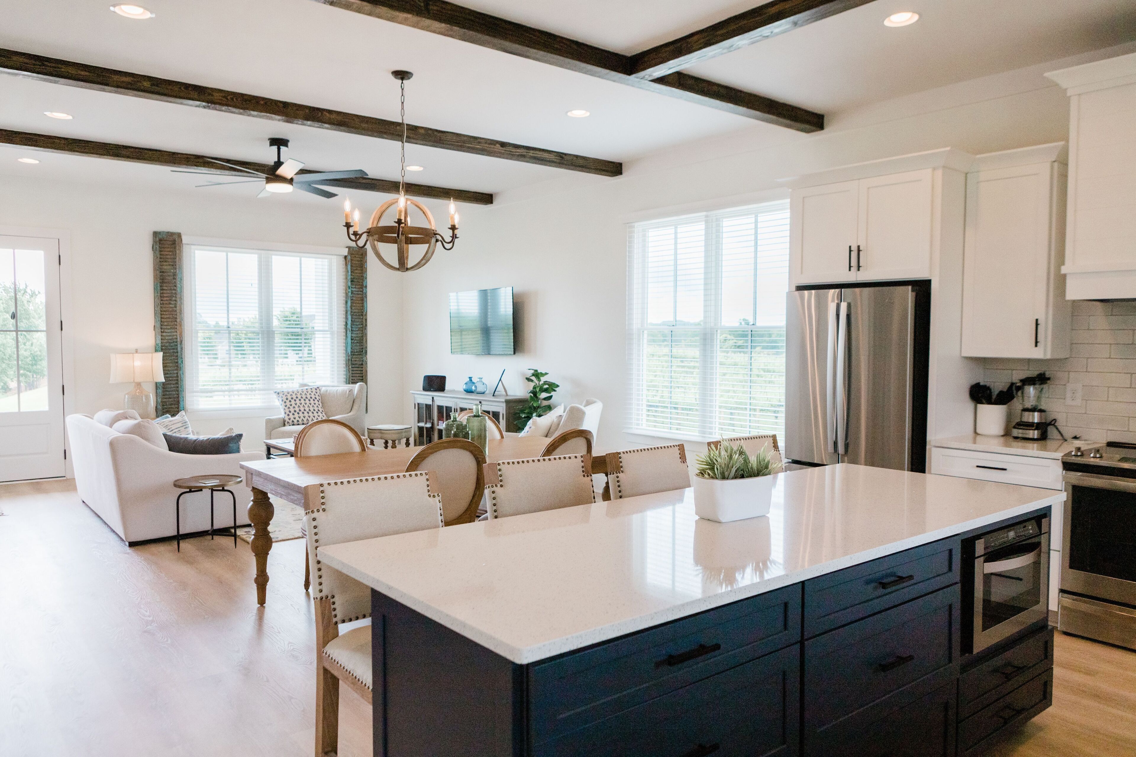 A spacious kitchen with a large island, modern appliances, and a dining area with a chandelier.
