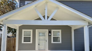 A house with a covered porch, a front door, and two windows. - PERFECT - LARGE CUSTOM HOME - Completely Renovated, Beautiful Fenced in Yard!!!! (Indianapolis)