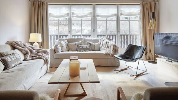 A cozy living room with a sofa, a coffee table, a chair, and a TV. - Casa Val de Ruda Luxe 71 by FeelFree Rentals (Baqueira)