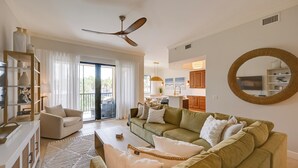 A spacious living area with a sofa, coffee table, and a ceiling fan. - Luxe Naples Bay Resort Condo: Near Fifth Ave! (Naples)