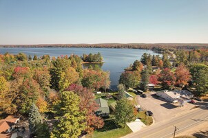 A lakeside property with a gas station, a small building, and a parking lot.