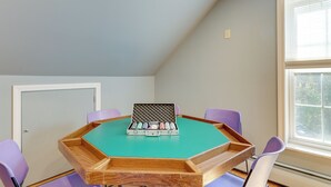 A room with a green table, purple chairs, a window, and a door. - Charming Chester Apartment: Steps to Main Street! (Chester)