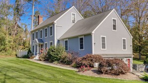 A two-story house with a gabled roof, a front porch, and a well-maintained lawn. - Charming Chester Apartment: Steps to Main Street! (Chester)