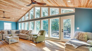 A spacious living room with a high ceiling, large windows, and a cozy seating area. - Waterfront Gilbertsville Retreat on Kentucky Lake! (Gilbertsville)