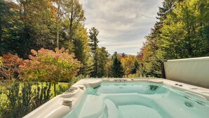 A hot tub surrounded by trees and greenery. - Winhall Home w/ Deck + Views, 6 Mi to Ski Slopes! (Bondville)