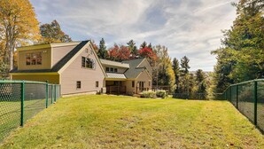 A two-story house with a large front yard and a fenced backyard. - Winhall Home w/ Deck + Views, 6 Mi to Ski Slopes! (Bondville)