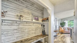 A rustic interior with a wooden wall, a bench, and a sofa in a well-lit room with a view of greenery outside. - 4bdmountain Getawaydog Friendlyminutes to Pikes Peak & Nature (Woodland Park)