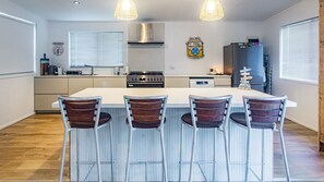 Fridge, dishwasher, cookware/dishes/utensils, dining tables - The Ohana Hut - 2 bed 2 bath Air conditioned home in town center -  walk to beach (Agnes Water)