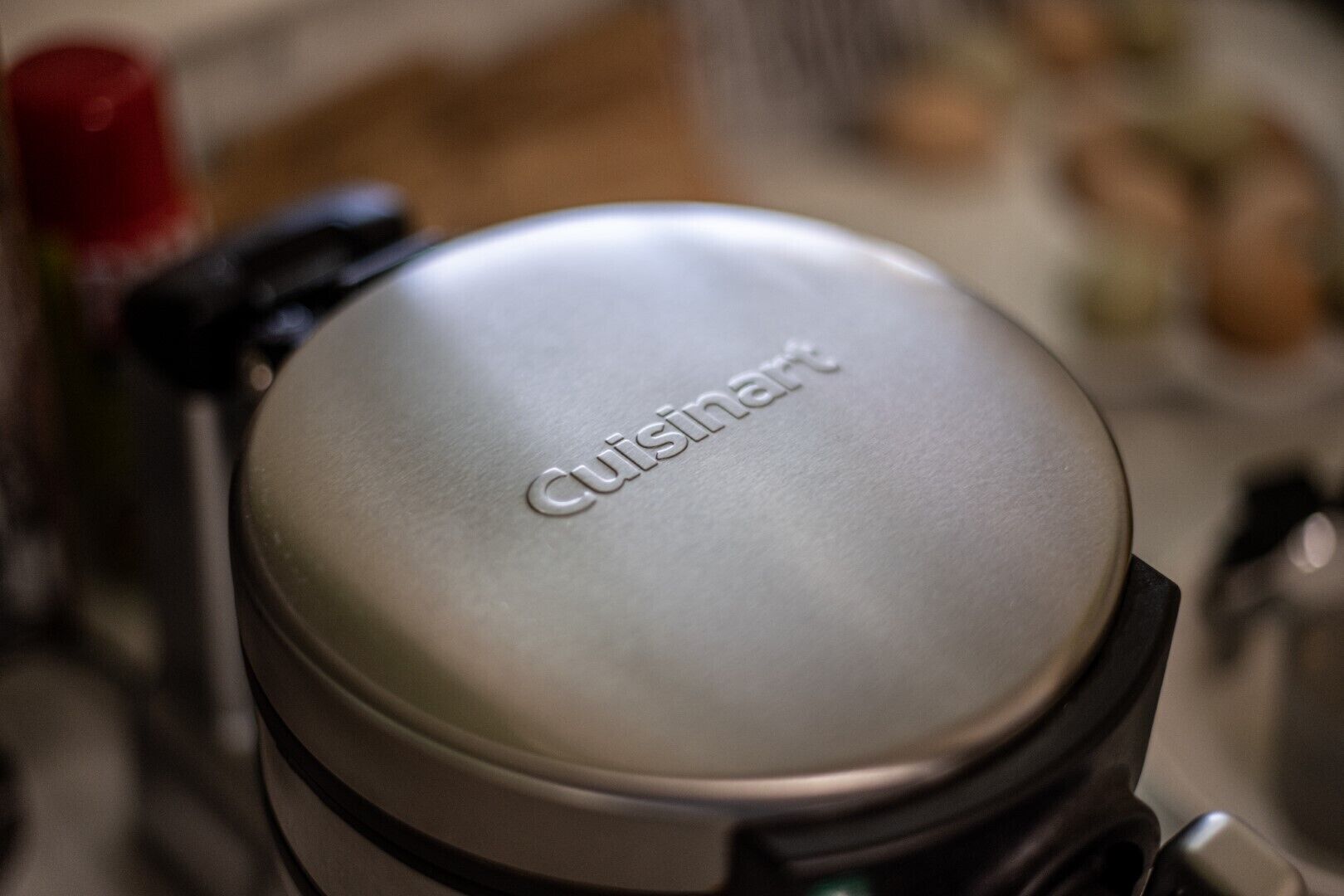 A kitchen appliance with the brand name "Cuisinart" on the lid.