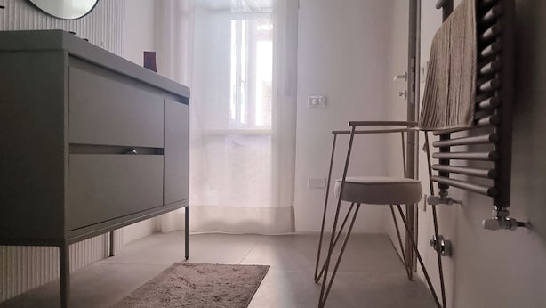 A narrow hallway with a radiator, a radiator cover, a mirror, a radiator vent, a radiator, a radiator cover, a radiator, a radiator cover, a radiator, a radiator cover, a radiator, a radiator cover, a radiator, a radiator cover, a radiator, a radiator cover, a radiator, a radiator cover, a radiator, a radiator cover, a radiator, a radiator cover, a radiator, a radiator cover, a radiator, a radiator cover, a radiator, a radiator cover, a radiator, a radiator cover, a radiator, a radiator cover, a radiator, a radiator cover, a radiator, a radiator cover, a radiator, a radiator cover, a radiator, a radiator cover, a radiator, a radiator cover, a radiator, a radiator cover, a radiator, a radiator cover, a radiator, a radiator cover, a radiator, a radiator cover, a radiator, a radiator cover, a radiator, a radiator cover, a radiator, a - Florence Design Apartment (Firenze)