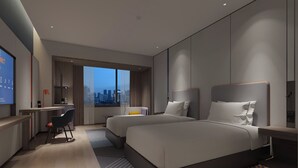 A modern hotel room with two beds, a desk, and a large window offering a city view. - Holiday Inn Express Changsha Development Zone by IHG (Changsha)