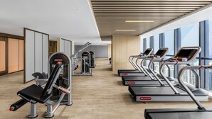 A gym with treadmills, weight machines, and a mirror. - Holiday Inn Express Changsha Development Zone by IHG (Changsha)