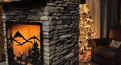 The Cozy Pines is a newly built, romantic log cabin with a 2-sided fireplace.