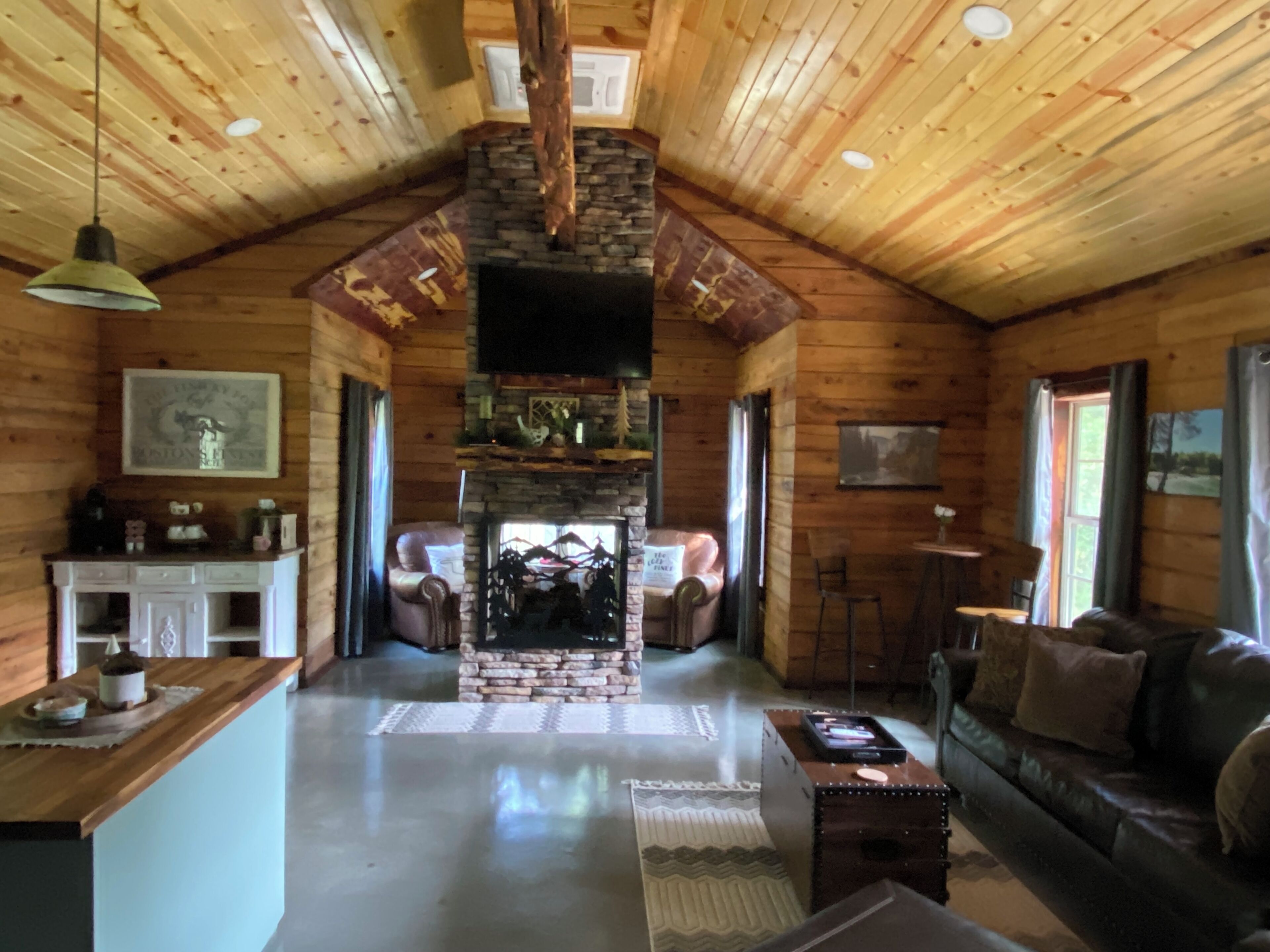 The Cozy Pines is a newly built, romantic log cabin with a 2-sided fireplace.