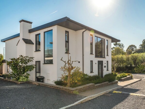 A modern two-story house with a white exterior, large windows, and a driveway. - Step into indulgence, where every detail is tailored for your comfort. (Cradley, near Malvern)