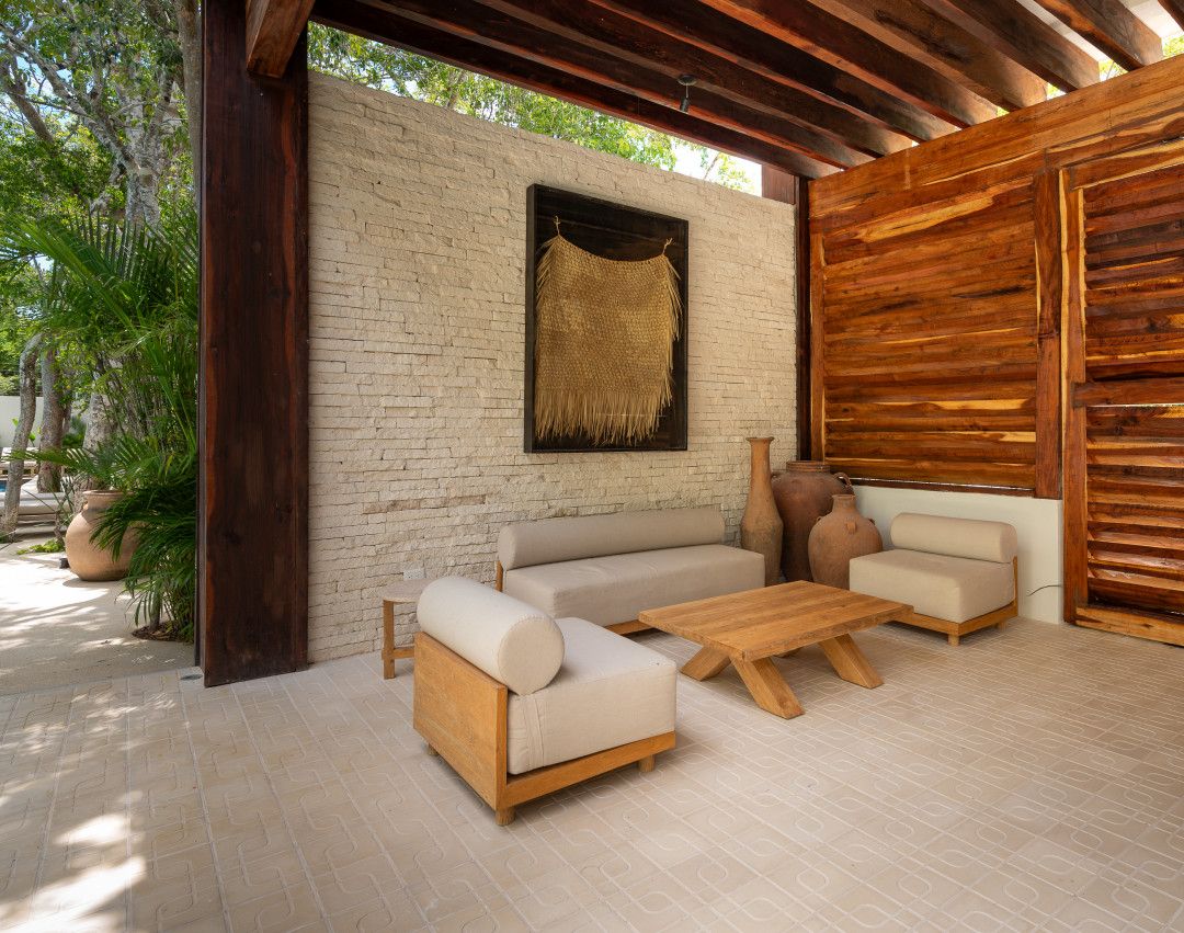 An outdoor seating area with a sofa, chairs, and a coffee table.