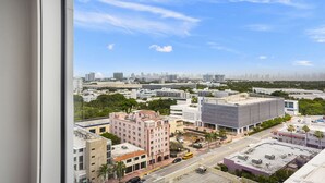 A cityscape with modern buildings, a clear sky, and a view of the skyline. - 1 Bedroom Private Residence at Roney Palace (Miami Beach)