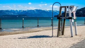 A beach with a lifeguard tower and a sign that reads "Lifeguards Only."