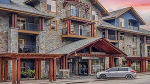 A multi-story lodge with stone facade, balconies, and a prominent entrance.