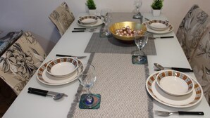 A dining table set with plates, cutlery, and a decorative bowl. - Captivating 2-bed Apartment in Edgbaston (Birmingham)