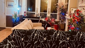 A living room with a piano, a drum set, and a couch. - RVH"S/
 Rm B  in a Home/Shared Living Space  (Surrey)
