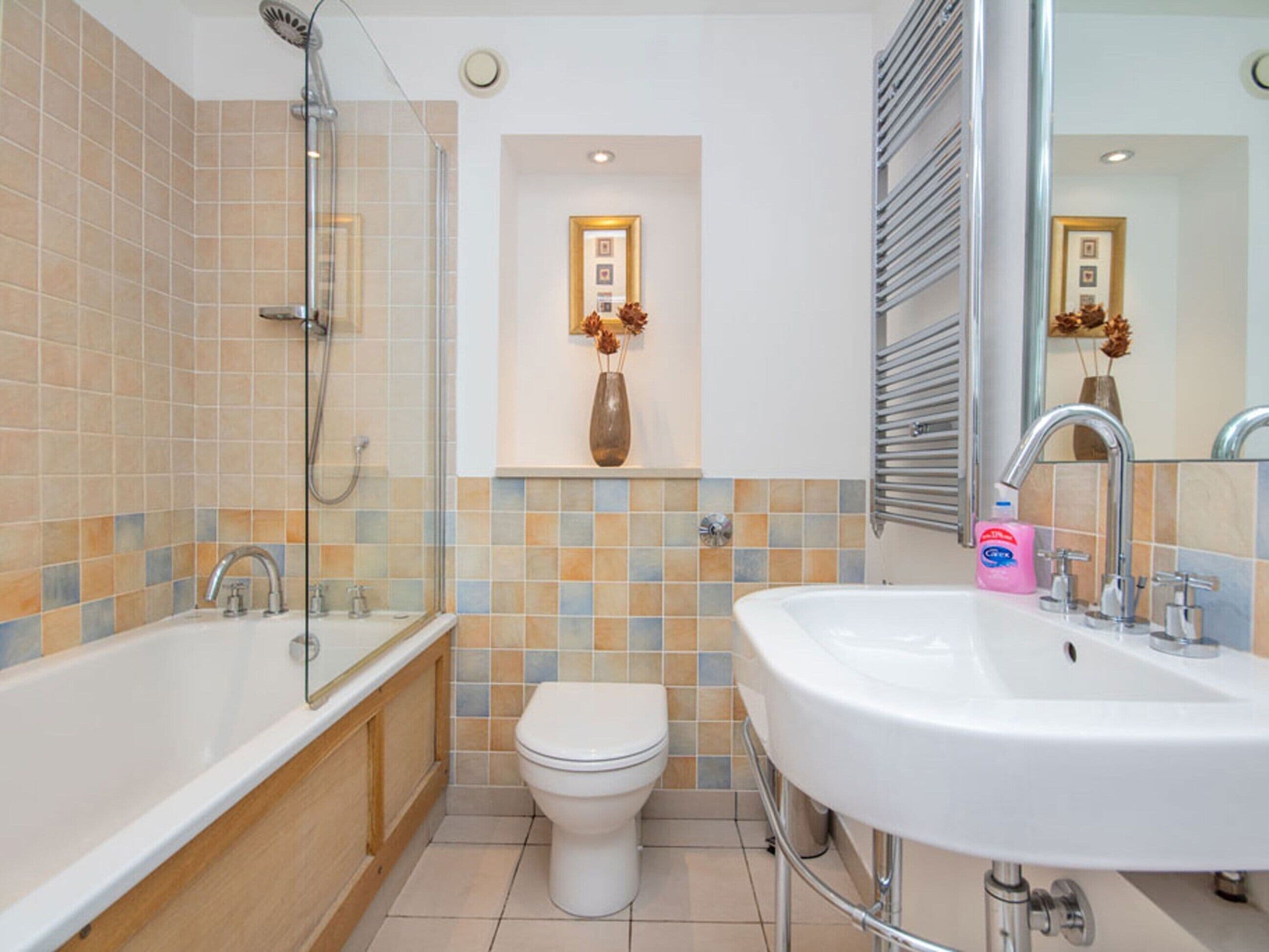 A bathroom with a bathtub, a sink, and a toilet.