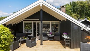 A modern house with a large deck, large windows, and outdoor furniture. - Awesome home in Egernsund with kitchen (Egernsund)