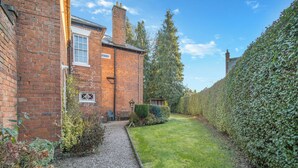 A brick house with a gravel path leading to a grassy yard. - 5 bedroom accommodation in Wem, near Shrewsbury (Wem, near Shrewsbury)