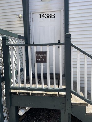 A white door with '1438B' above it and a sign stating 'Entrance for Unit B'. - Claiborne Guest House w/pool by Historic Getaways (New Orleans)