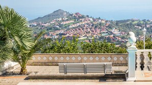 A pool with a view of a hillside town.