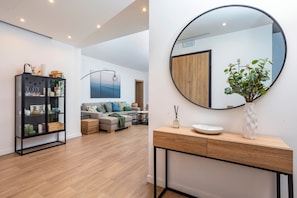 A modern living room with a sofa, a coffee table, and a black cabinet with glass doors. - Apartment 'Antonia House' with Sea View, Wi-Fi and Air Conditioning (Acicastello)