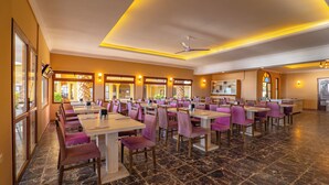 A spacious restaurant with marble flooring, purple chairs, and white tables. - Dream Holiday Resort  (Burhaniye)