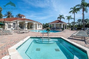 A resort with a swimming pool, lounge chairs, and palm trees. - 4BR Resort Home, 2 King Suites. Disney 9 min. Pools/Tennis/Pickleball/Gym/Sauna (Kissimmee)