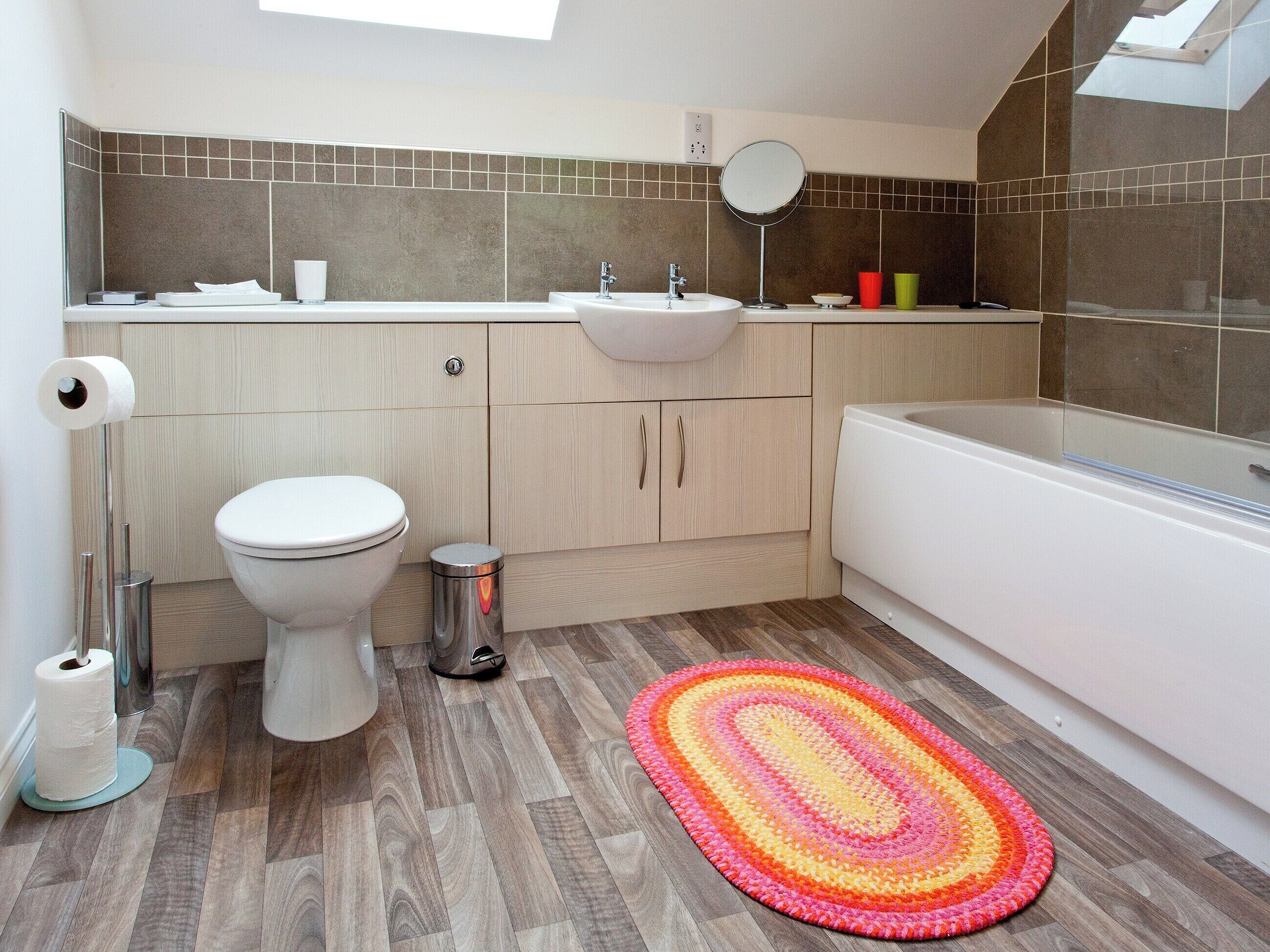 A modern bathroom with a toilet, sink, and bathtub.