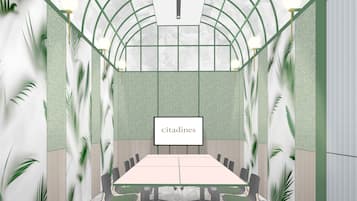 A conference room with a long table, chairs, and a 'citadines' sign.