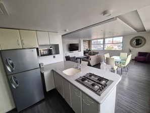 Fridge, microwave, cookware/dishes/utensils, dining tables