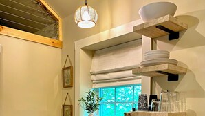A compact kitchen with a sink, a coffee maker, and a microwave. - Charming Cottage Retreat in Lewistown – Sleeps 4 (Lewistown)