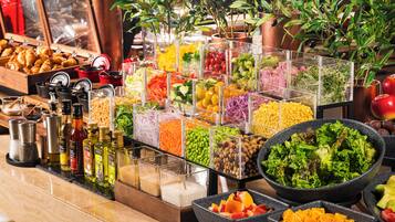A buffet with various food items and condiments.