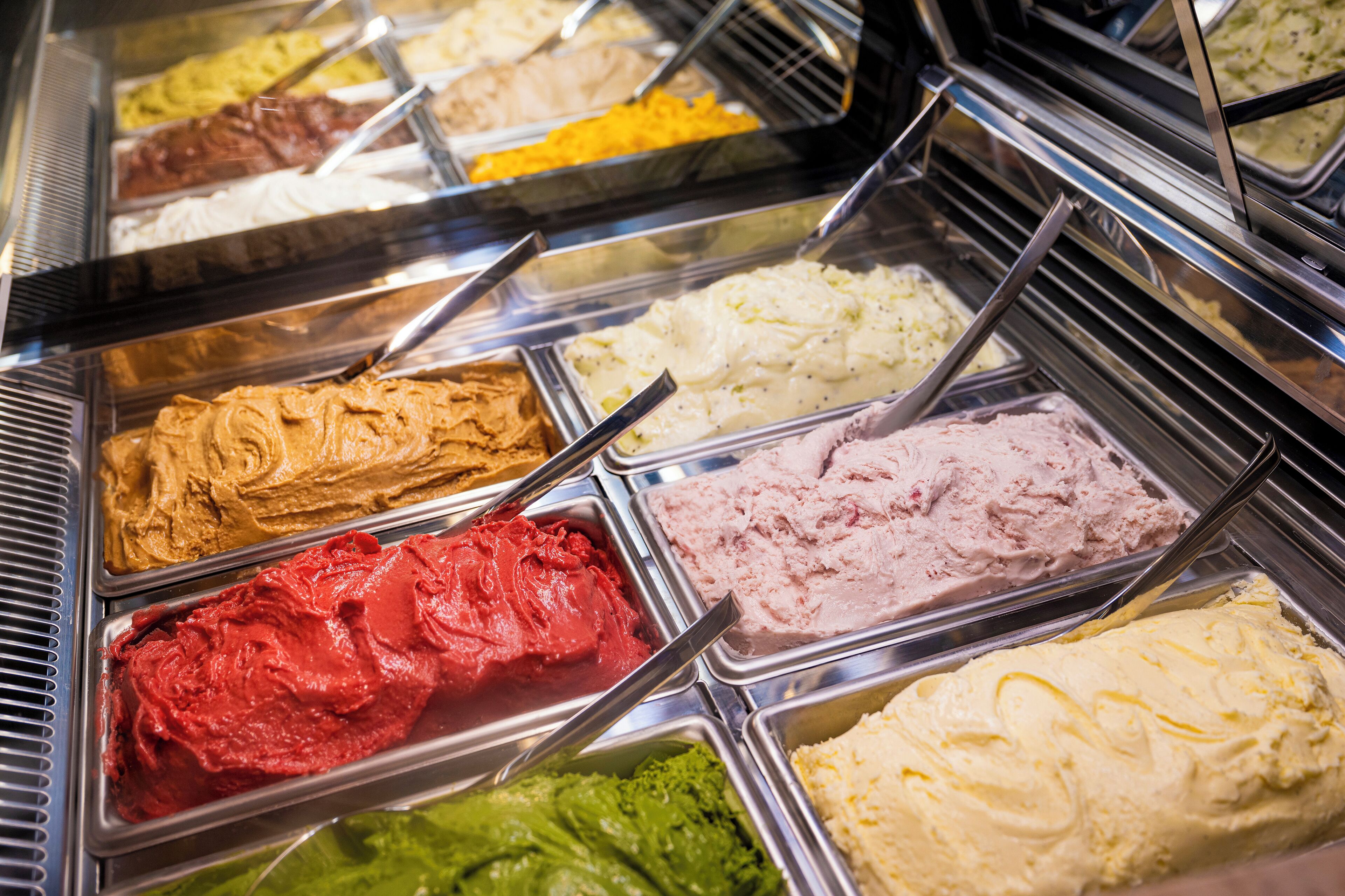 A variety of ice cream flavors in a display case.
