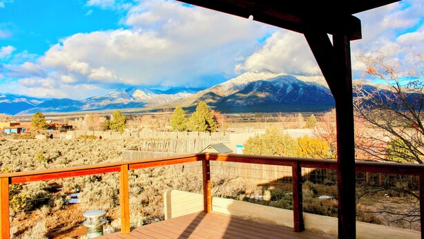 A wooden deck with a view of a mountainous landscape. - Entire home with privacy and views 10 mins to town 25mins to ski area  (El Prado)