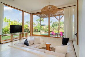 Deluxe Villa, 3 Bedrooms | Living area | 35-inch flat-screen TV with satellite channels - Gigi Sun Villa by Betterplace (Canggu)
