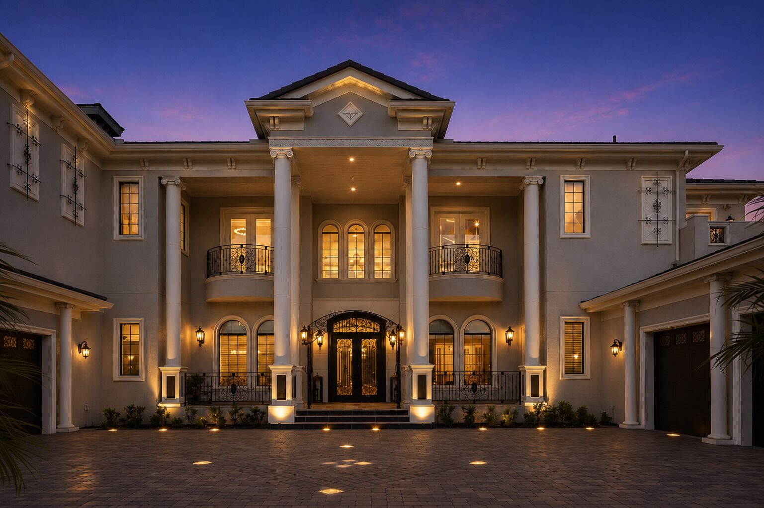 A large, stately building with a grand entrance, multiple balconies, and a symmetrical facade.
