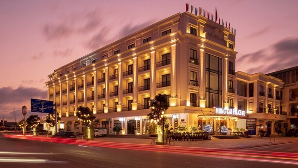 A large, multi-story hotel with a classic architectural design, featuring balconies and large windows. - Móng Cái Place (Mong Cai)