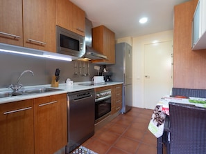 Enjoy cooking in this well-equipped kitchen with a sink, microwave, oven, and dishwasher.