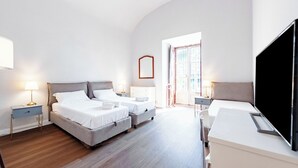 A modern hotel room with two beds, a flat-screen TV, and a large window. - Nobel - Historic Center, Genova, Italy (Genova)