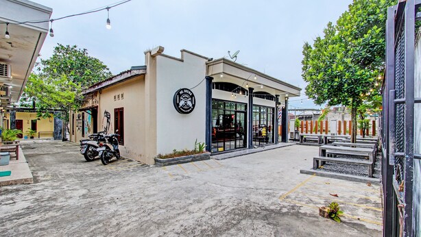 A building with a storefront and a parking area.