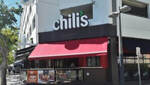 A Chili's restaurant with a red awning and outdoor seating area.