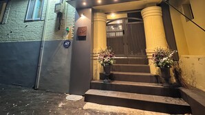 A building with a balcony, a set of stairs leading to a door, and a sign indicating the entrance. - Steps away from DDP, Airport Bus, DongDaeMun Shopping Malls [Timeless Rooftop] (Seoul)
